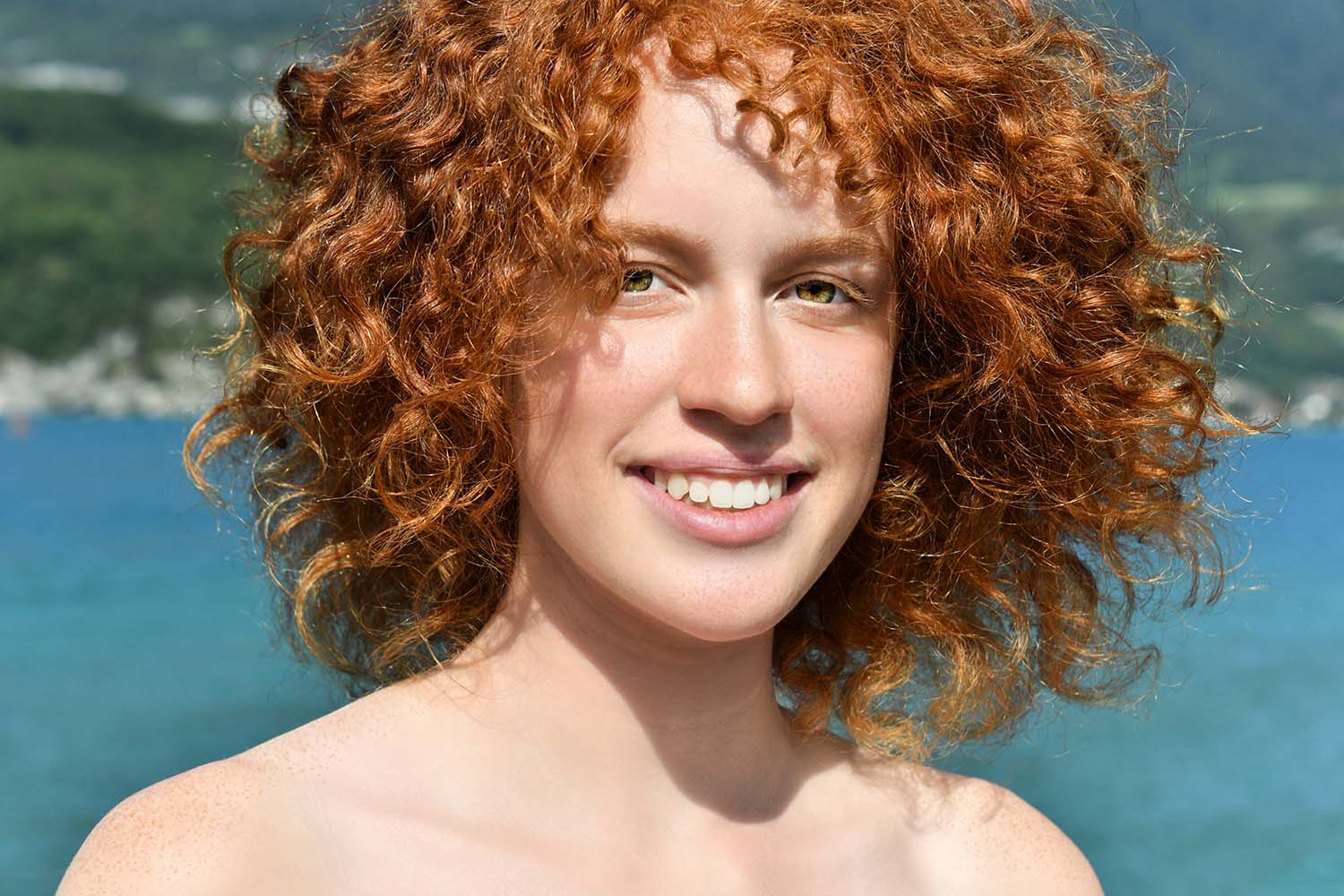 Portrait of Cléophée, facing forward, with Lake Annecy in the background, France.
