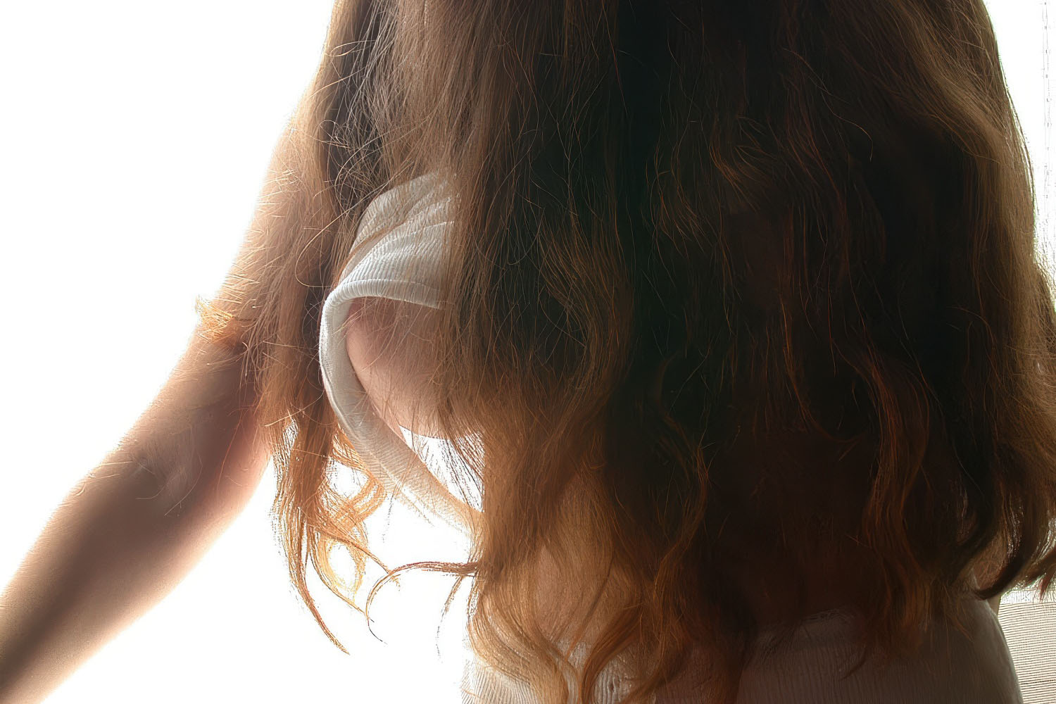 Close-up artistic portrait of hair and bust.